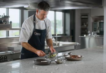 Chef Christopher Britton preparing food in a kitchen
