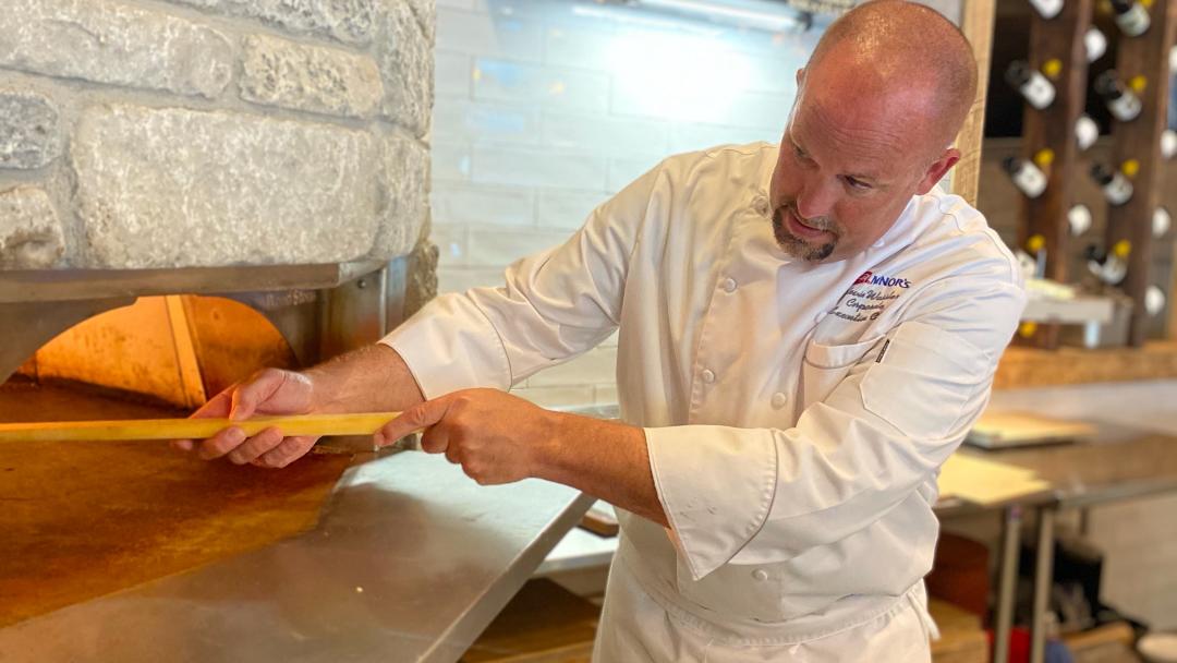 Chef Kevin Wassler using a brick oven