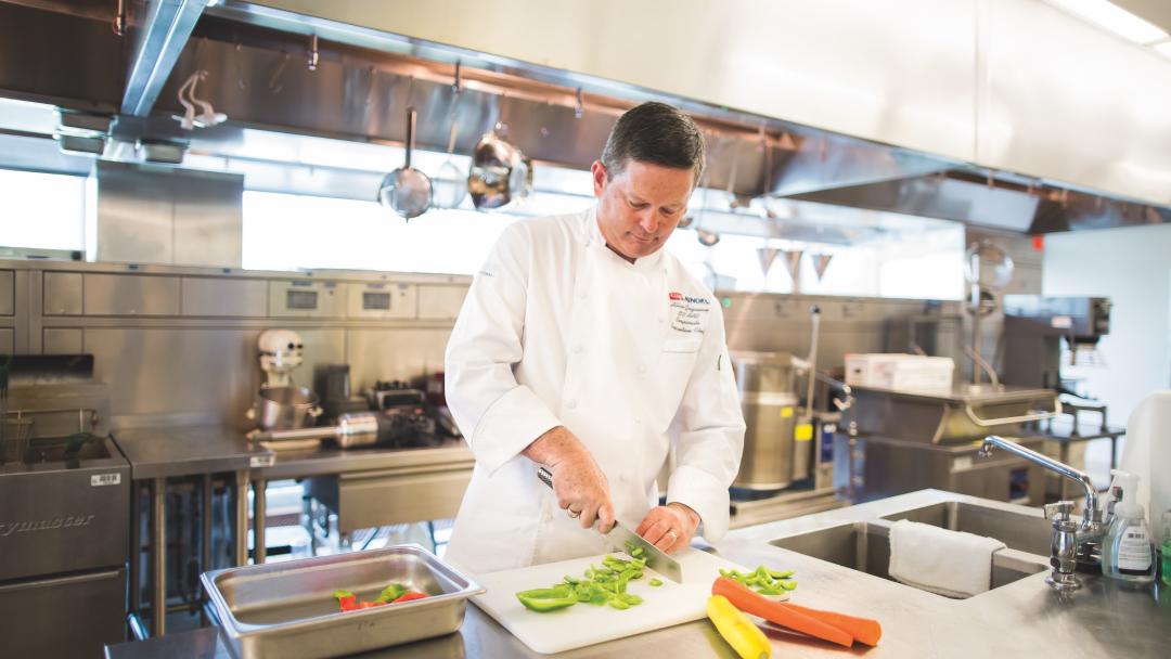 Chef Allan Gazaway chopping up peppers in the kitchen