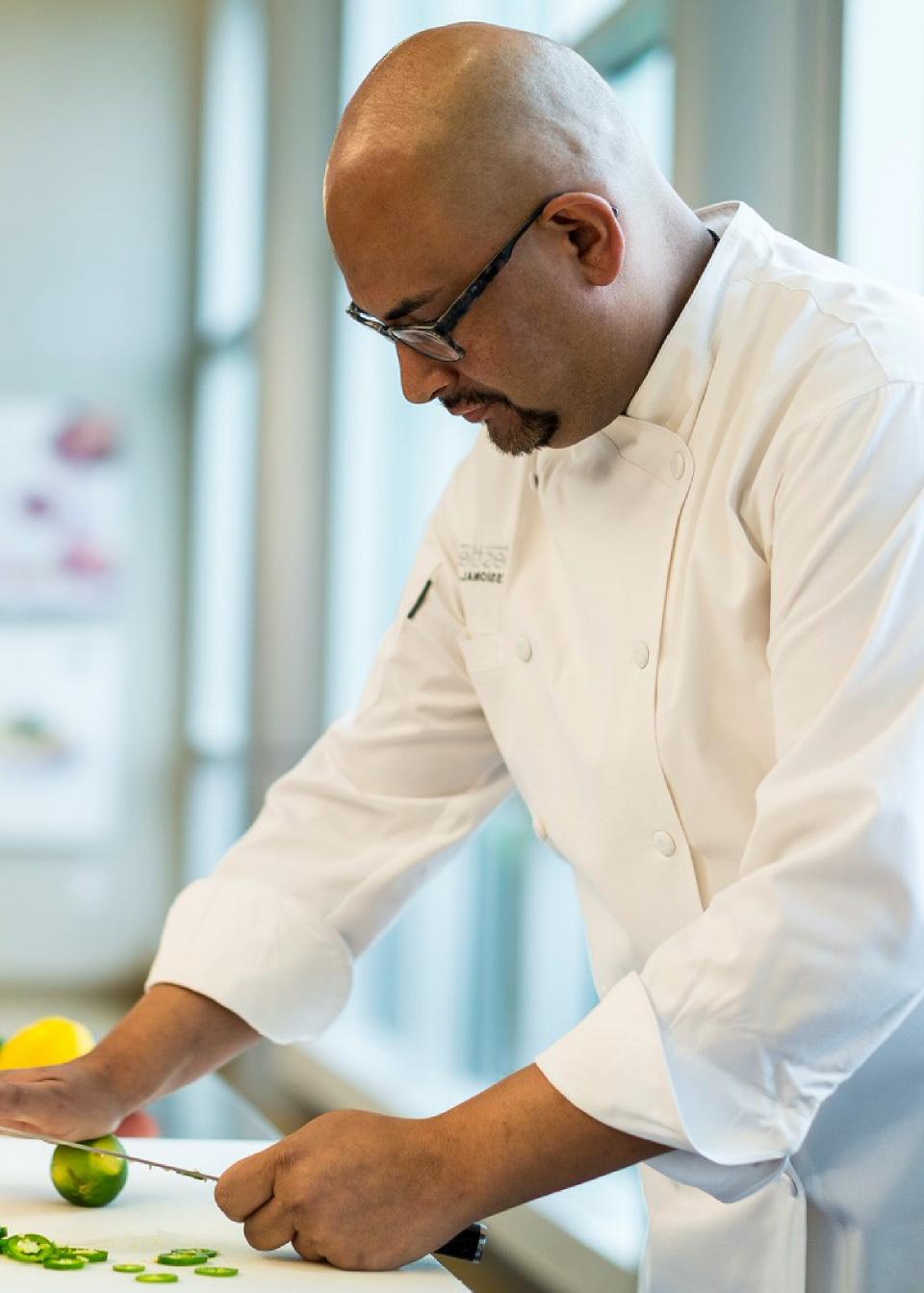 Chef Orlando Apodaca cutting a lime in the kitchen