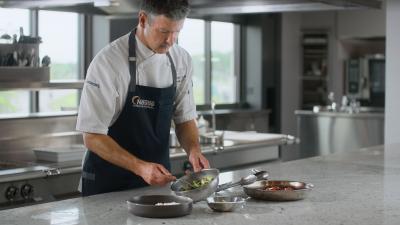 Chef Christopher Britton preparing food in a kitchen