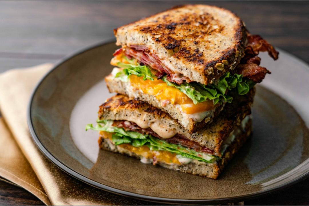 Smoky BLT sliced in half on a plate