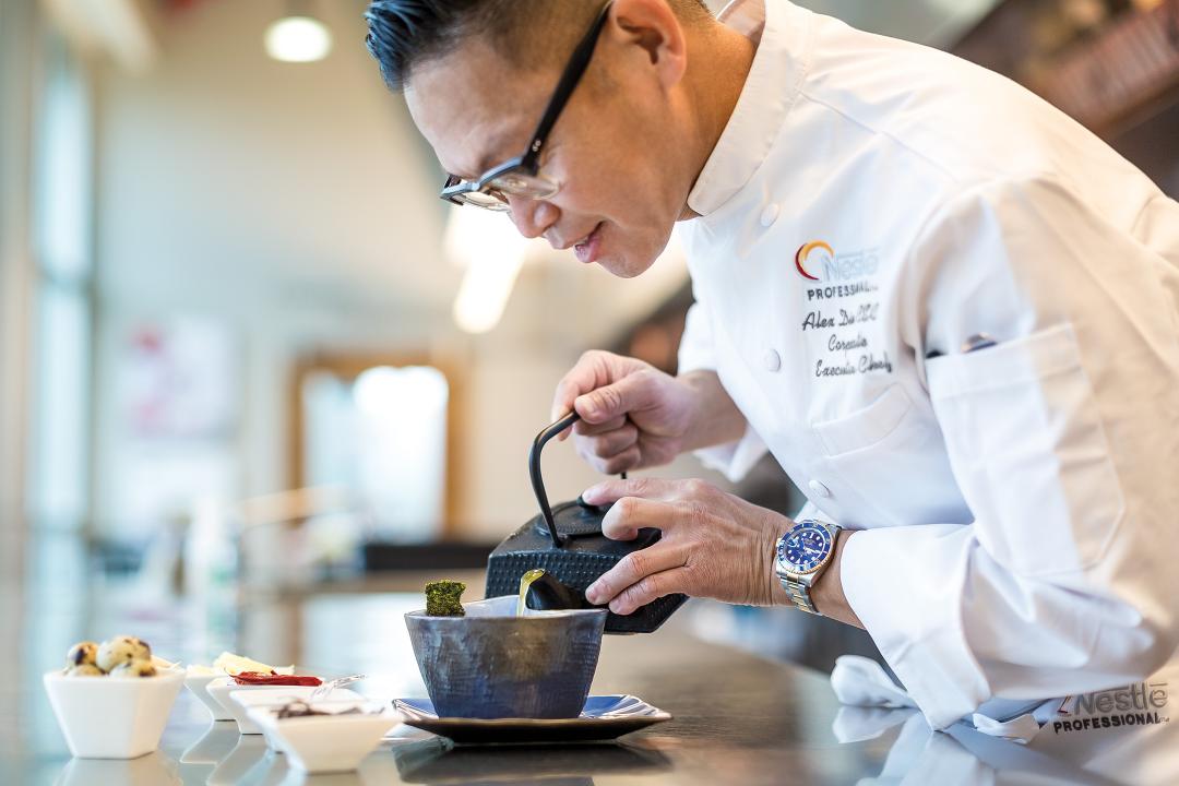 Alex Dino pouring broth into a dish