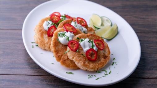 Four Ancho Chile & Cheese Pupusas on a plate with limes