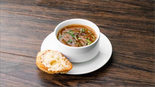 Five Onion Soup in a bowl with bread