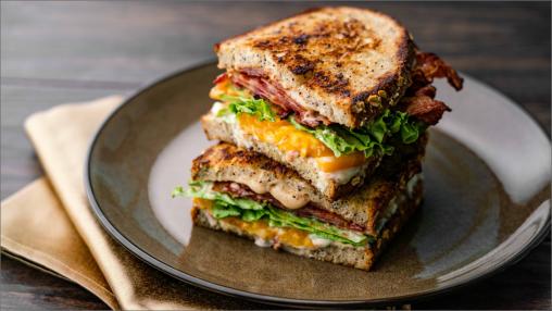 Smoky BLT sliced in half on a plate