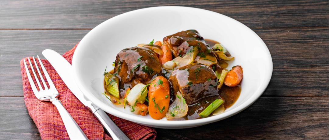 Sunday Pot Roast in a dish with napkin and silverware